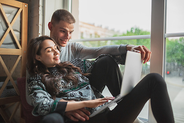 Image showing Quarantine lockdown, stay home concept - young beautiful caucasian couple enjoying new lifestyle during coronavirus worldwide health emergency