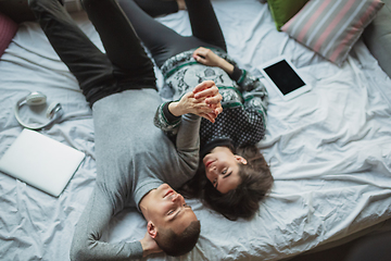 Image showing Quarantine lockdown, stay home concept - young beautiful caucasian couple enjoying new lifestyle during coronavirus worldwide health emergency