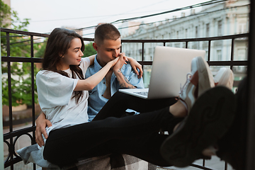 Image showing Quarantine lockdown, stay home concept - young beautiful caucasian couple enjoying new lifestyle during coronavirus worldwide health emergency