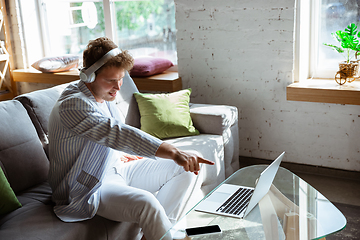 Image showing Caucasian man during online concert at home isolated and quarantined, impressive improvising, listening to band playing