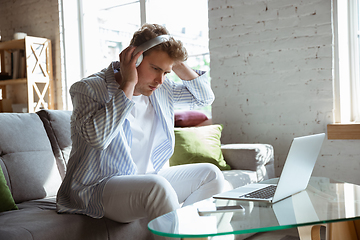 Image showing Caucasian man during online concert at home isolated and quarantined, impressive improvising, listening to band playing