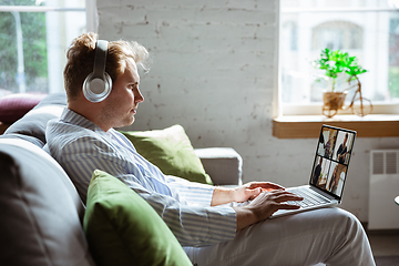 Image showing Caucasian man during online concert at home isolated and quarantined, impressive improvising, listening to band playing