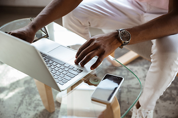 Image showing Close-up of male fingers typing a business document, note or search key on the laptop