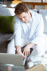 Image showing Caucasian man during online concert at home isolated and quarantined, impressive improvising, listening to band playing