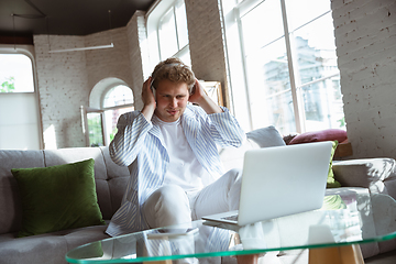 Image showing Caucasian man during online concert at home isolated and quarantined, impressive improvising, listening to band playing