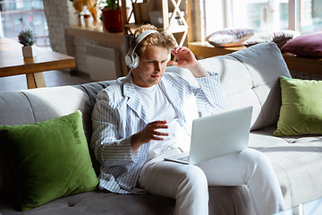 Image showing Caucasian man during online concert at home isolated and quarantined, impressive improvising, listening to band playing