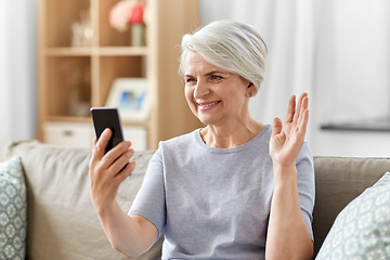 Image showing senior woman having video call on smartphone