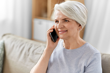 Image showing senior woman calling on smartphone at home