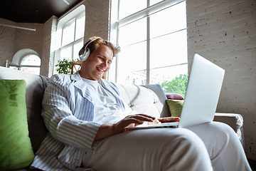 Image showing Caucasian man during online concert at home isolated and quarantined, impressive improvising, listening to band playing