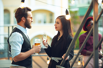 Image showing Man and woman celebrating, look happy, have corporate party at office or bar
