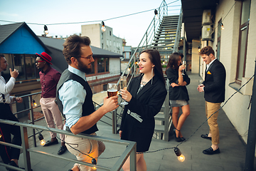 Image showing Group of young caucasian people celebrating, look happy, have corporate party at office or bar