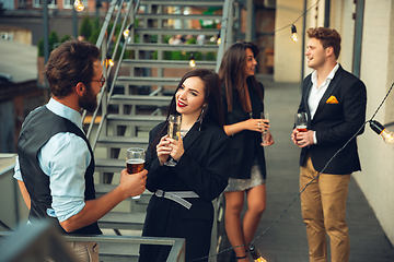 Image showing Group of young caucasian people celebrating, look happy, have corporate party at office or bar