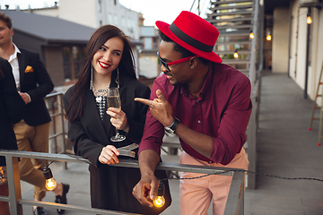 Image showing Group of young people celebrating, look happy, have corporate party at office or bar