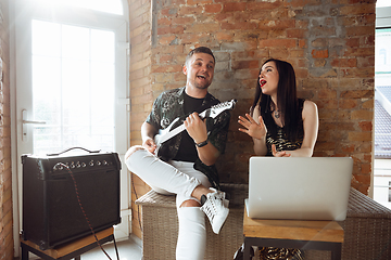 Image showing Caucasian musicians during online concert at home insulated and quarantined, cheerful and happy, impressive improvising