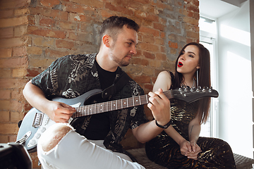 Image showing Caucasian musicians during online concert at home insulated and quarantined, cheerful and happy