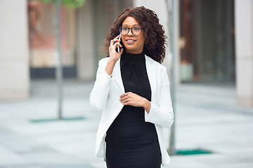 Image showing Beautiful african-american well-dressed businesswoman looks confident and busy, successful