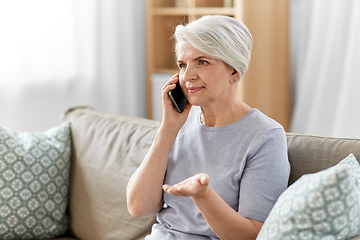 Image showing senior woman calling on smartphone at home