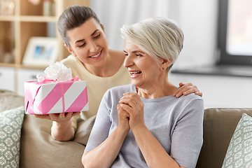 Image showing adult daughter giving present to her senior mother