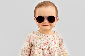 Image showing happy little baby girl in sunglasses over grey
