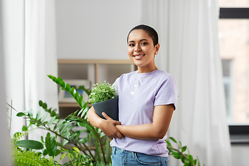 Image showing african american woman with plants at home