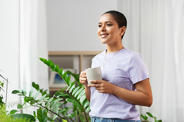 Image showing african american woman drinking coffee at home