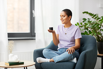 Image showing african american woman with smart speaker at home