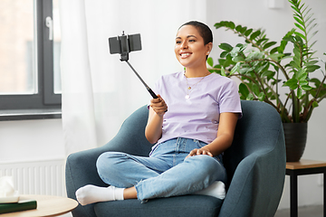 Image showing happy african american woman taking selfie at home