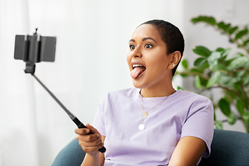 Image showing happy african american woman taking selfie at home