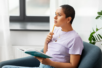 Image showing african american woman with diary at home