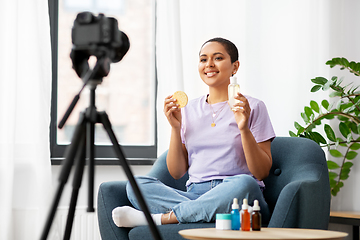 Image showing female beauty blogger with camera and cosmetics