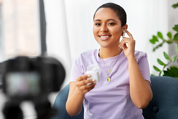 Image showing female blogger with camera video blogging at home