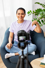 Image showing female blogger with camera video blogging at home