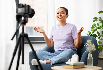 Image showing female blogger with camera video blogging at home