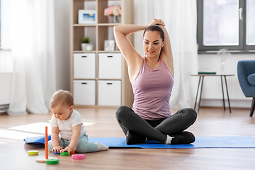 Image showing happy mother with little baby exercising at home