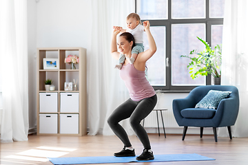 Image showing happy mother with little baby exercising at home