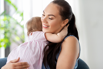 Image showing happy mother hugging little baby daughter at home