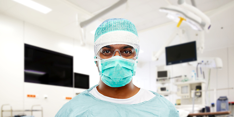 Image showing indian male surgeon in mask over operating room