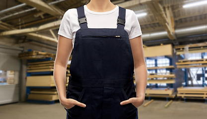 Image showing close up of female worker in overall at factory