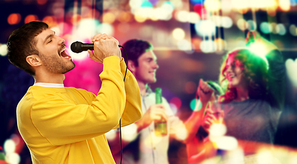 Image showing man with microphone singing at night club