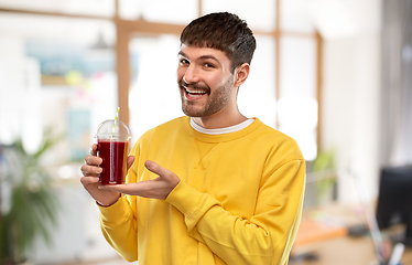 Image showing happy man with juice in plastic cup at office