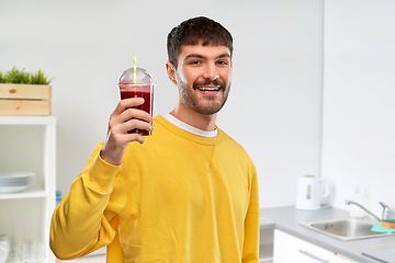 Image showing happy man with tomato juice in takeaway cup