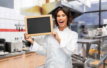 Image showing happy female chef holding chalkboard at kebab shop