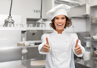 Image showing smiling female chef in toque showing thumbs up