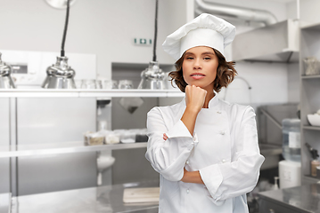 Image showing female chef in toque thinking