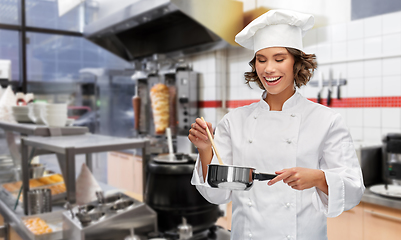 Image showing smiling female chef with saucepan at kebab shop