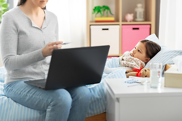 Image showing ill daughter and mother with laptop at home