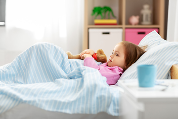 Image showing sick little girl lying in bed at home