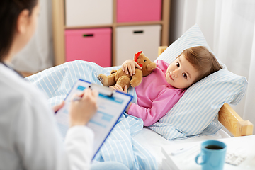 Image showing doctor with clipboard and sick girl in bed at home