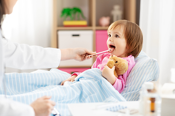 Image showing doctor checking sick girl's throat at home