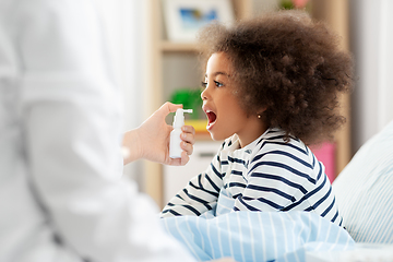 Image showing doctor with medicine treats sick girl at home